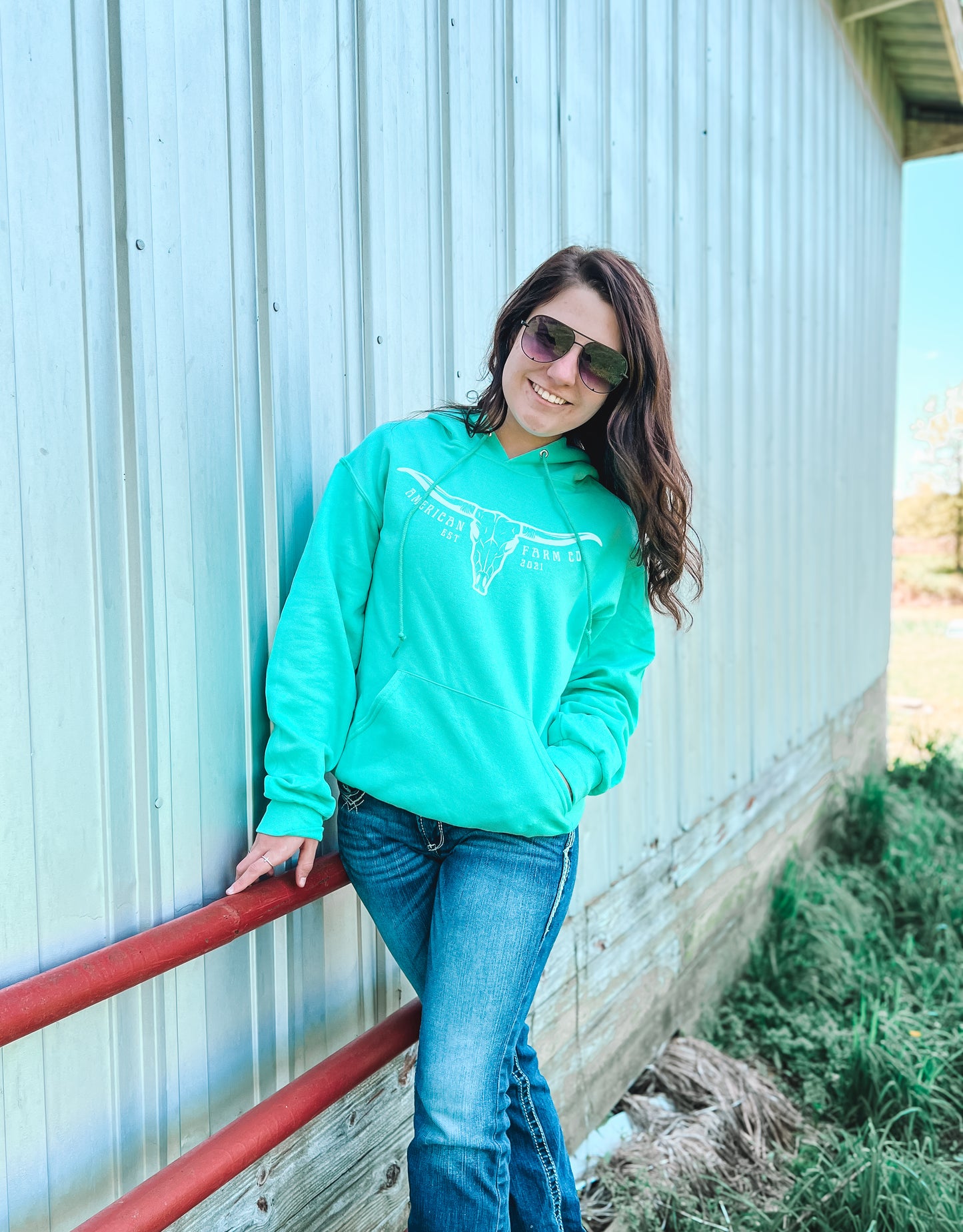 Teal Hoodie on Brunette with white bull skull print and American Farm Company logo