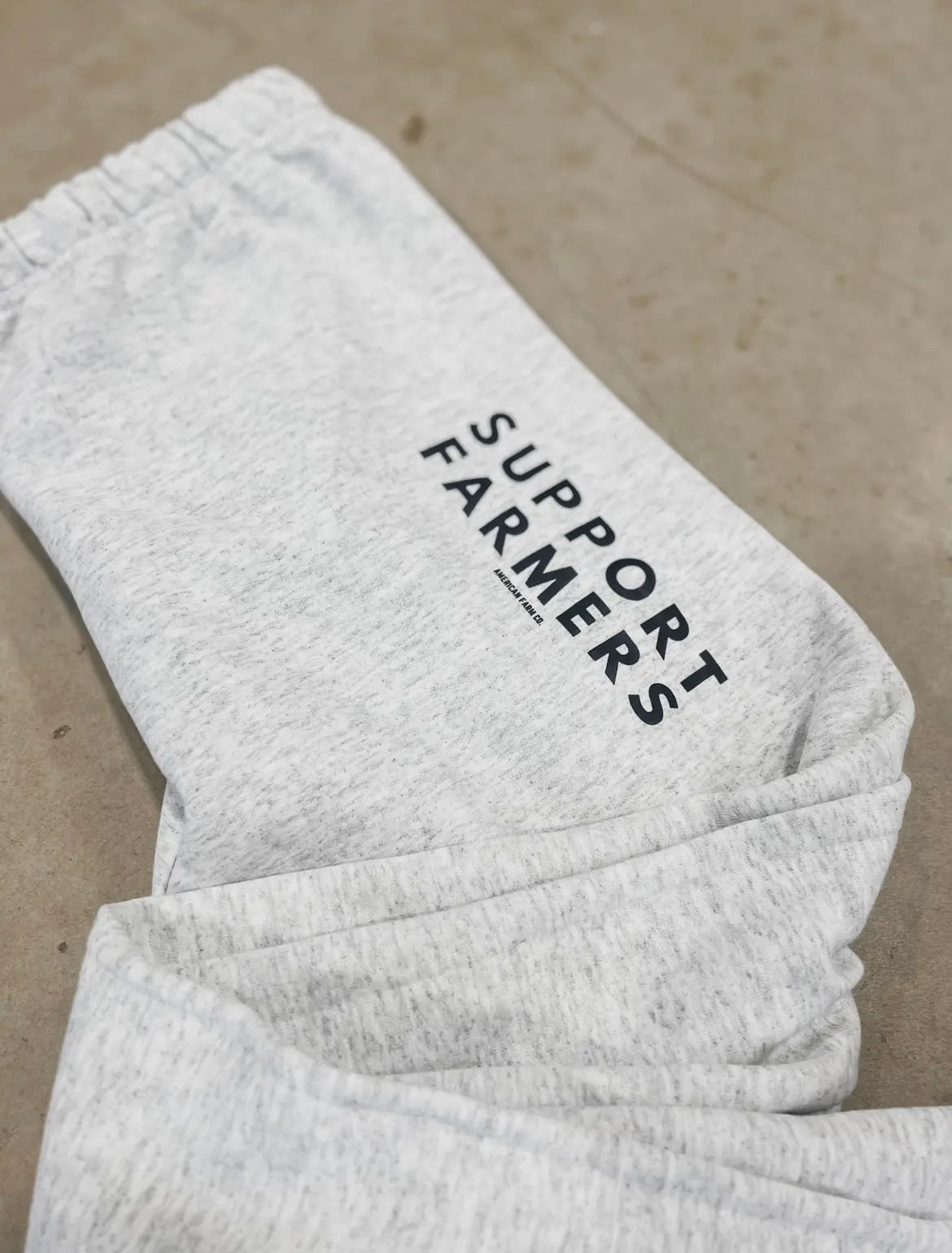 Flatlay of Grey "Support Farmers" Sweatpants