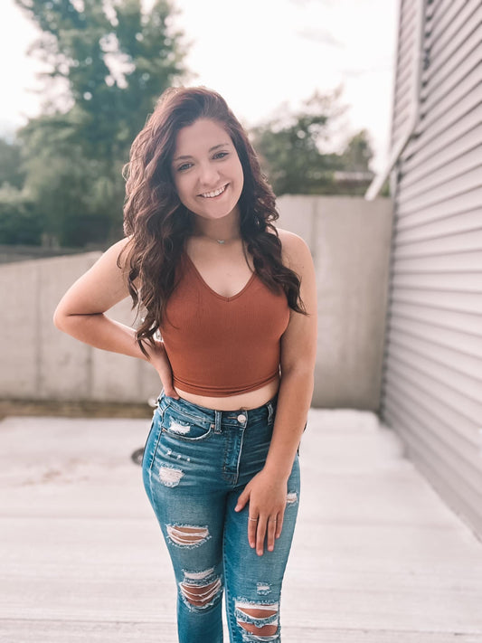 Burnt Orange colored sleeveless crop top on model