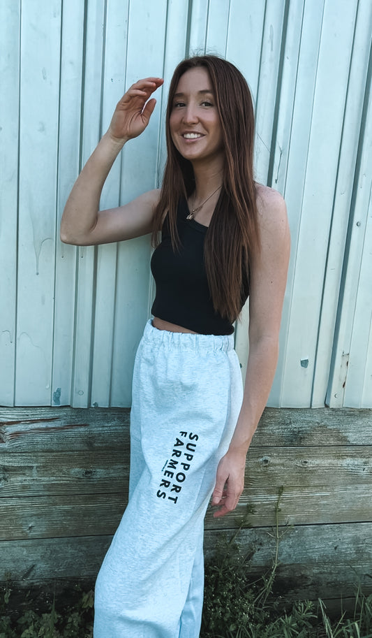 Grey Sweatpants on model that say "Support Farmers"