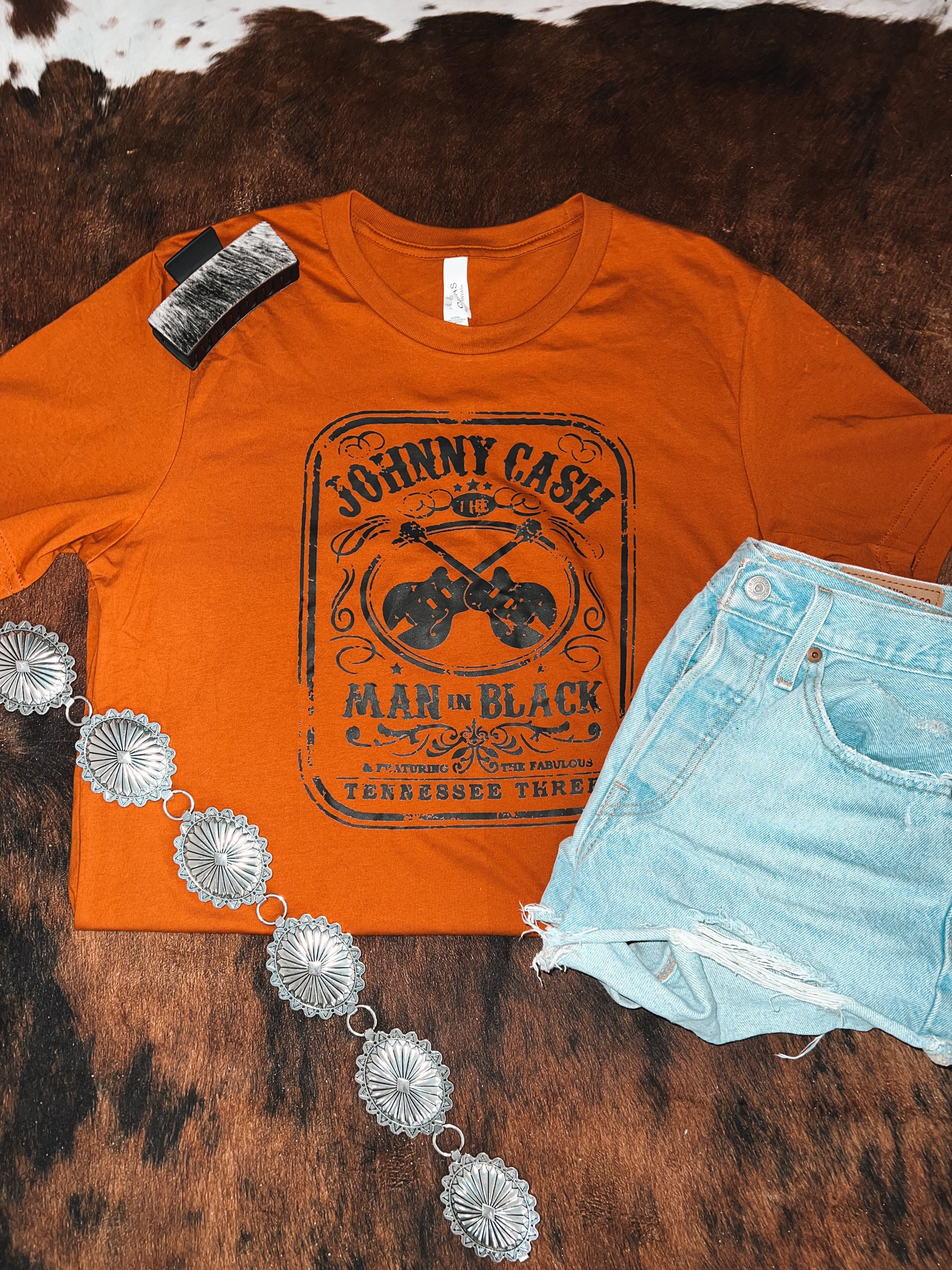 Flatlay of Burnt Orange Johnny Cash inspired graphic tee 